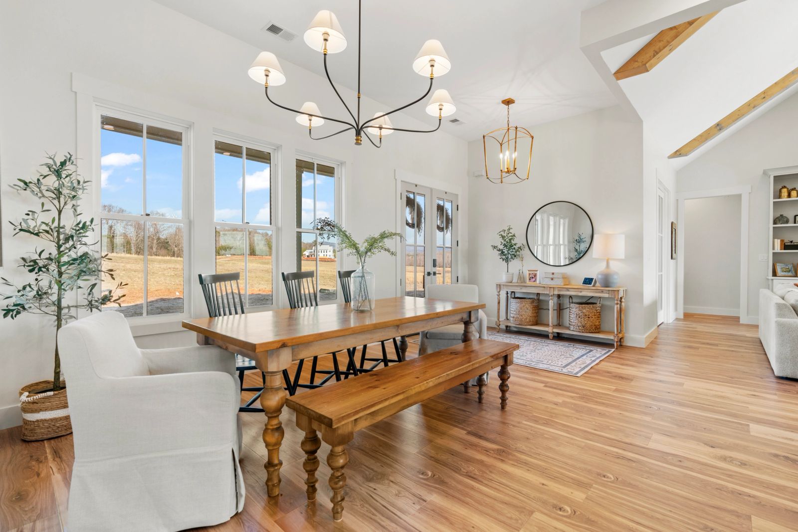 Dining room with timber beams and sculptural lighting